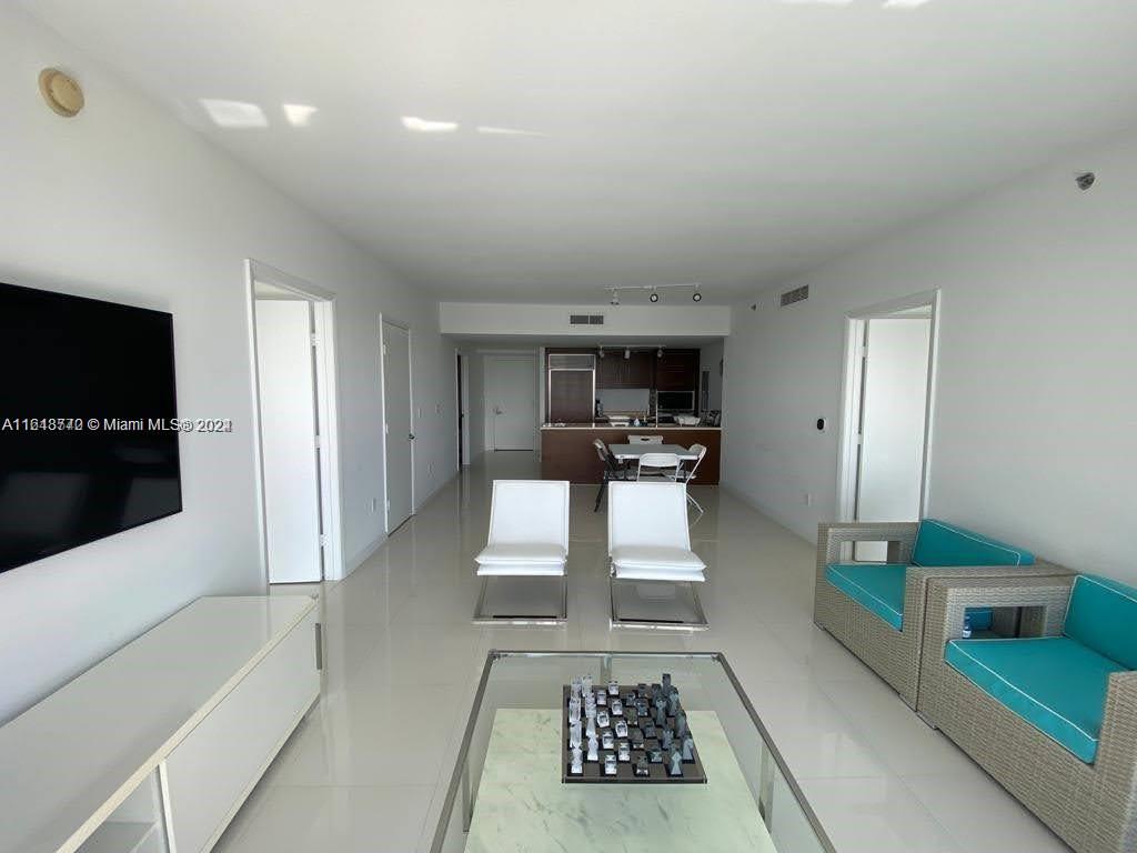 a view of living room with furniture and a flat screen tv