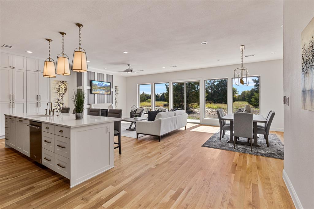 a living room with furniture dining table and a wooden floor