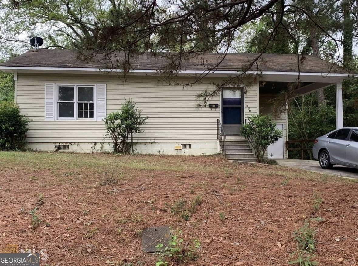 a front view of a house with garden