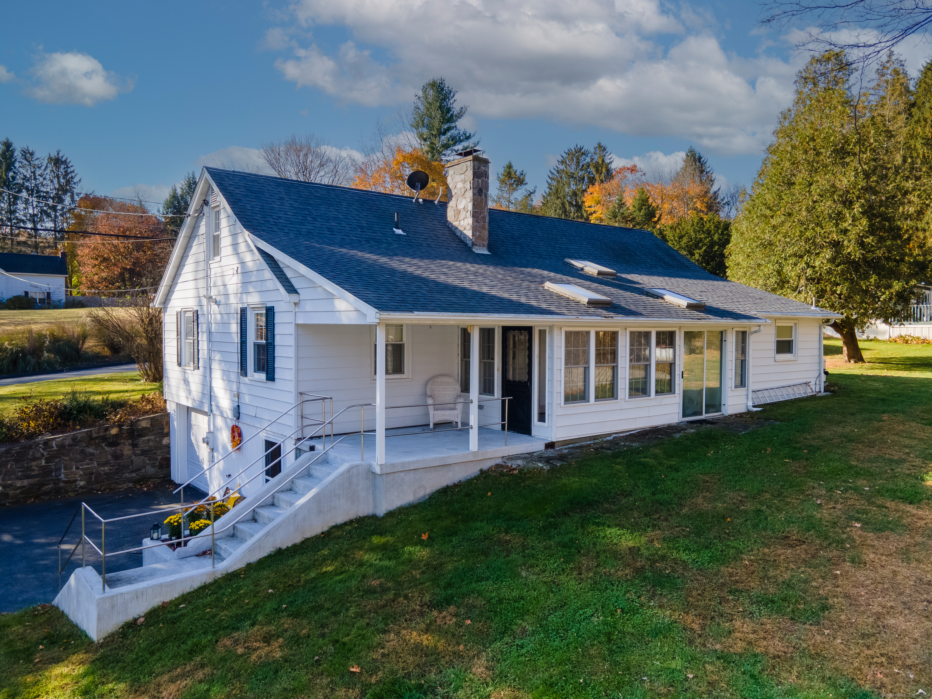 a front view of house with a garden and patio