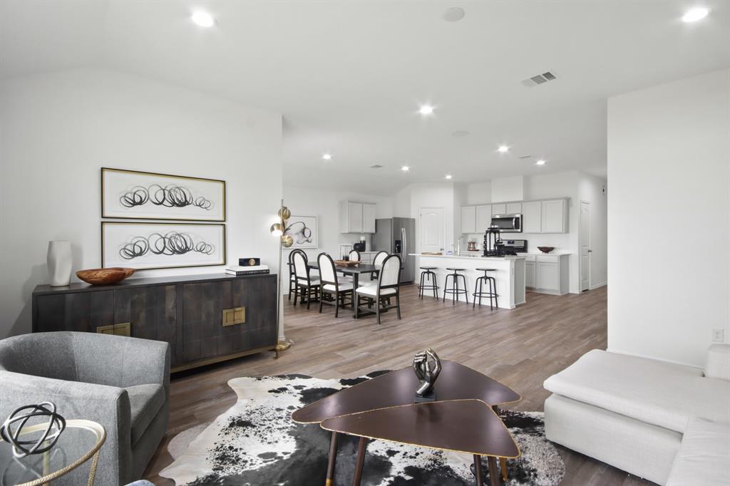 a living room with furniture and kitchen view