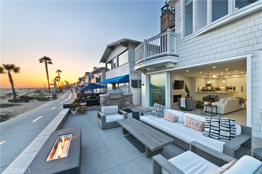 a view of a patio with couches table and chairs and potted plants