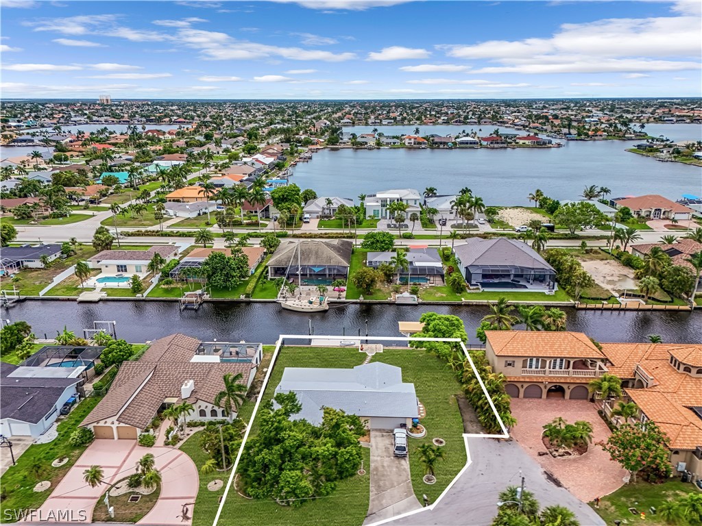 an aerial view of residential houses with outdoor space and ocean view