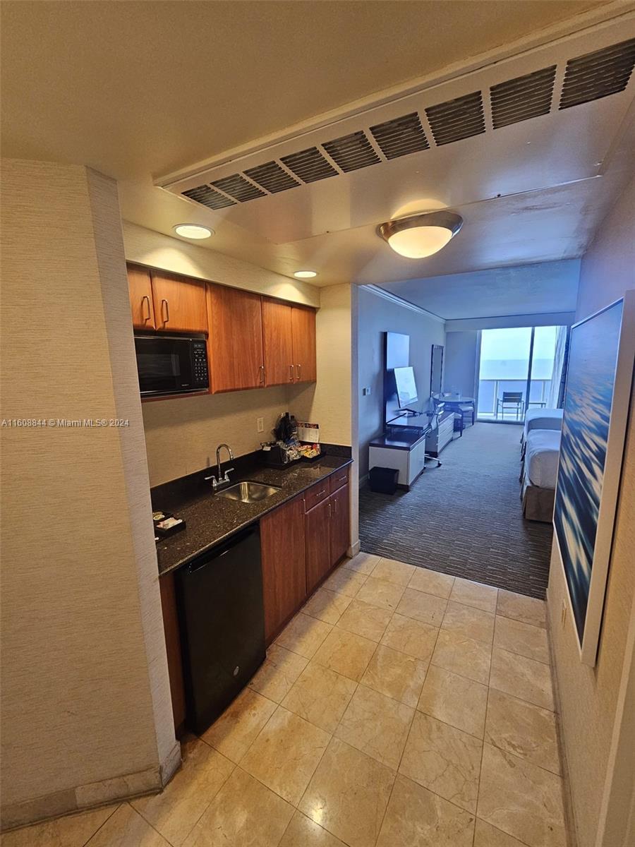 a kitchen with stainless steel appliances granite countertop a refrigerator and a stove