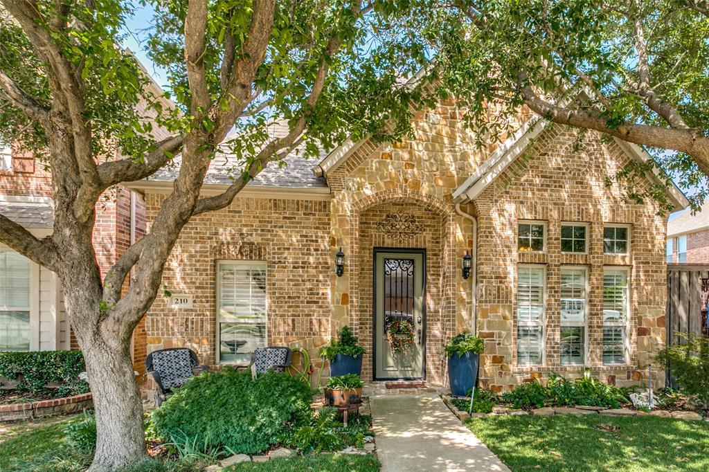 front view of a brick house with a yard