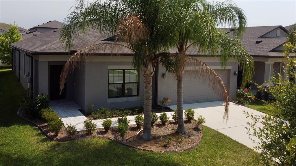 a backyard of a house with yard and outdoor seating