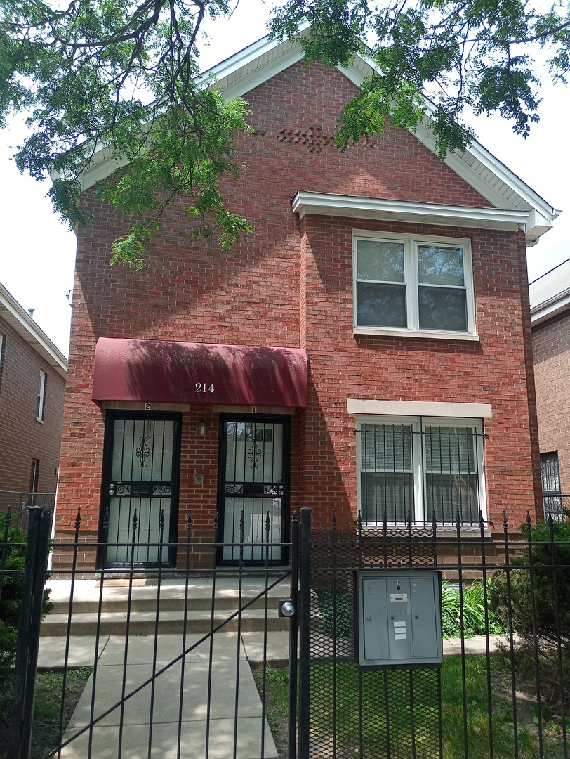 a front view of a house with glass windows and a table