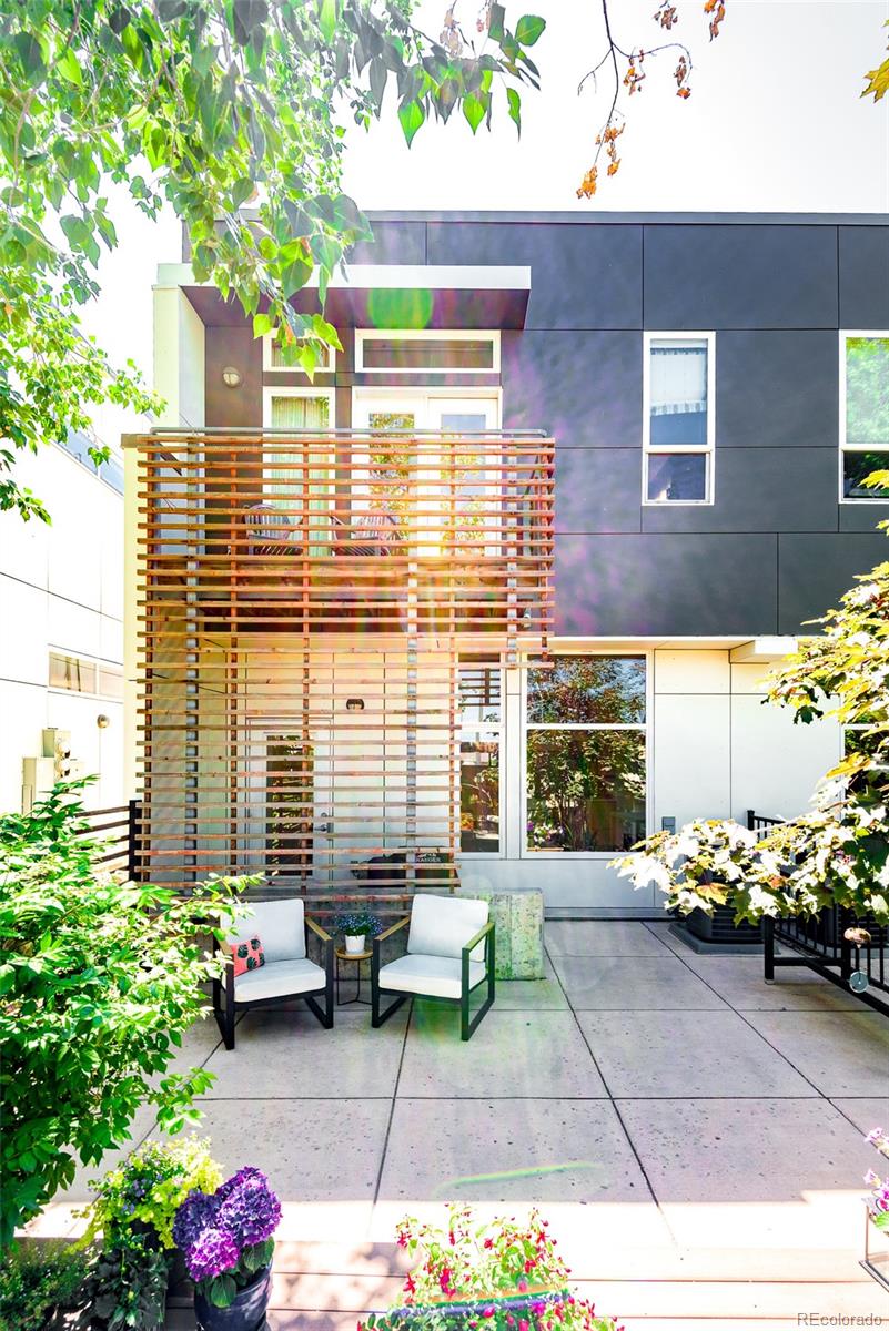 a backyard of a house with outdoor seating