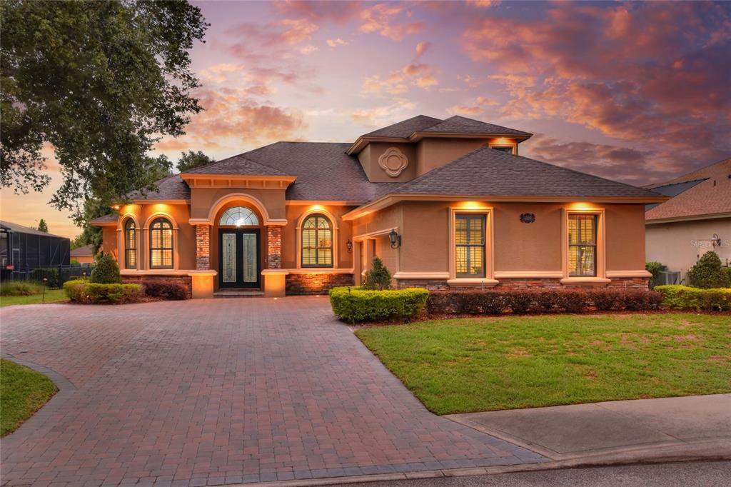 a front view of a house with a garden and yard