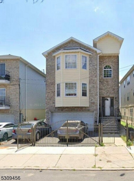 a front view of a house with parking space