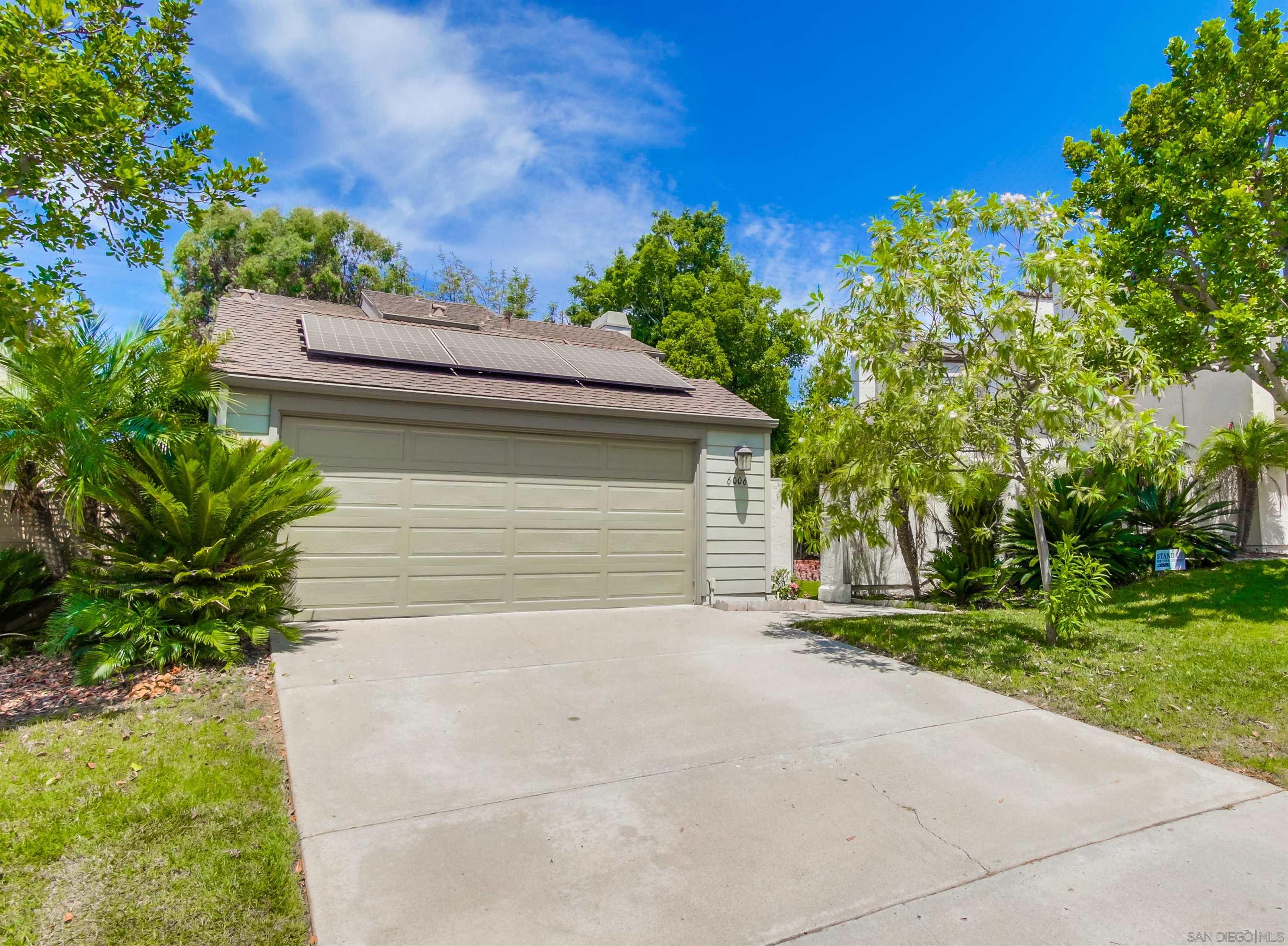 a view of a house with a yard and garage