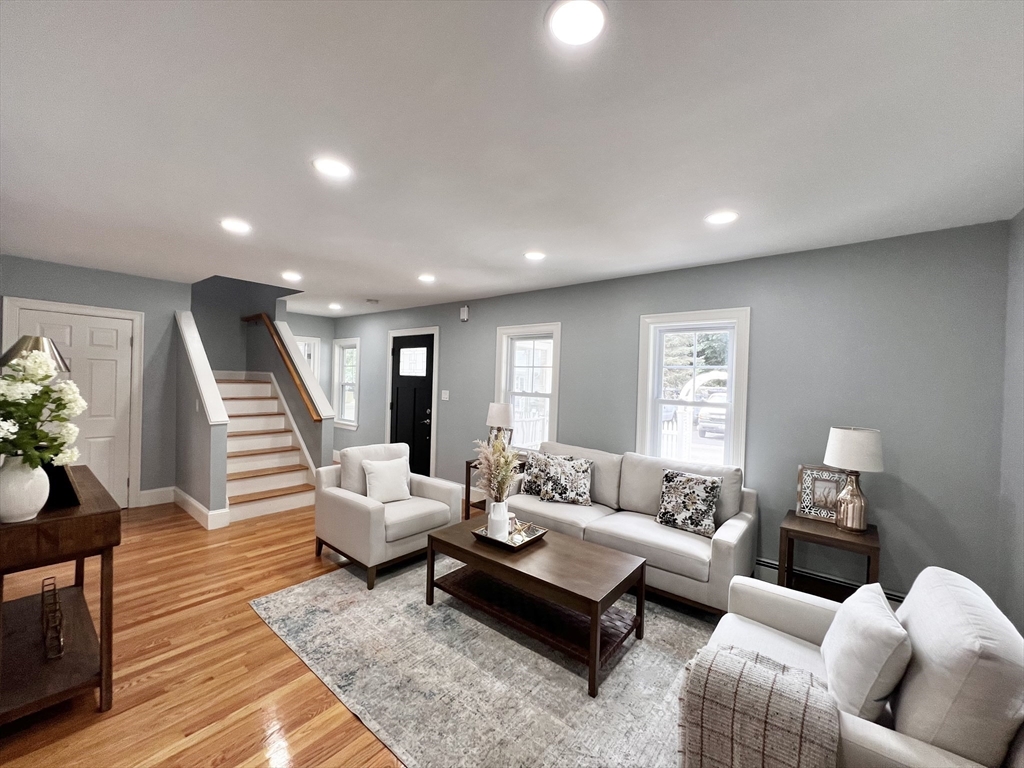 a living room with furniture and wooden floor