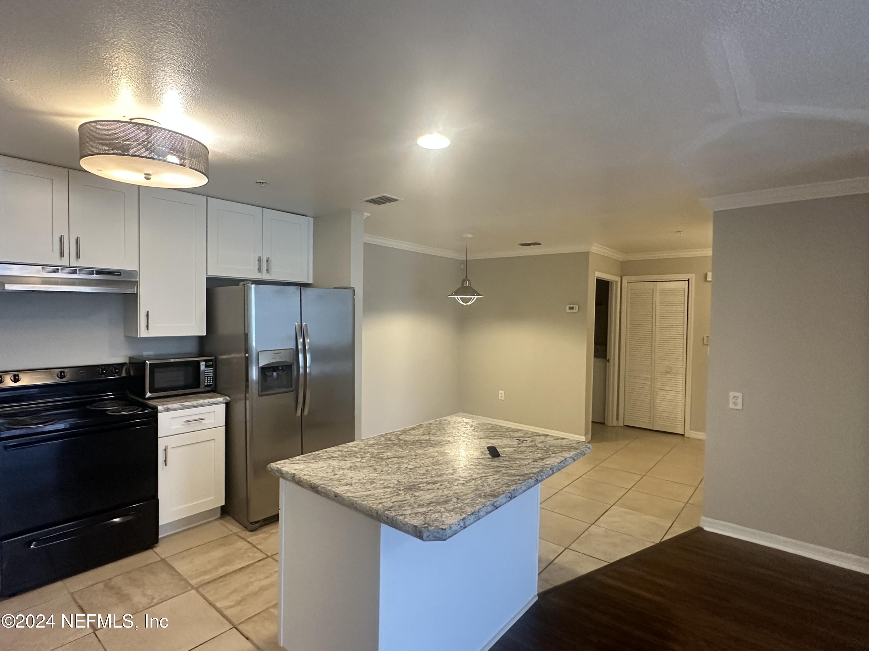 a kitchen with cabinets and stainless steel appliances