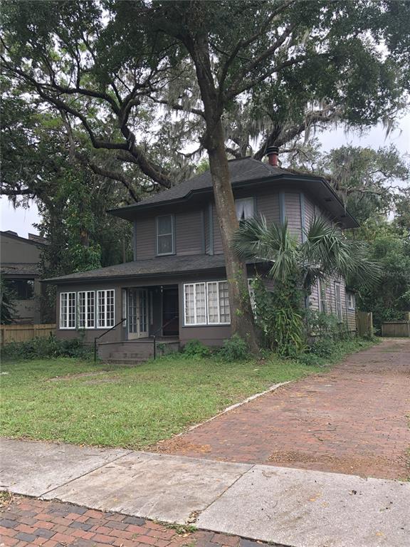 a front view of a house with a garden and yard