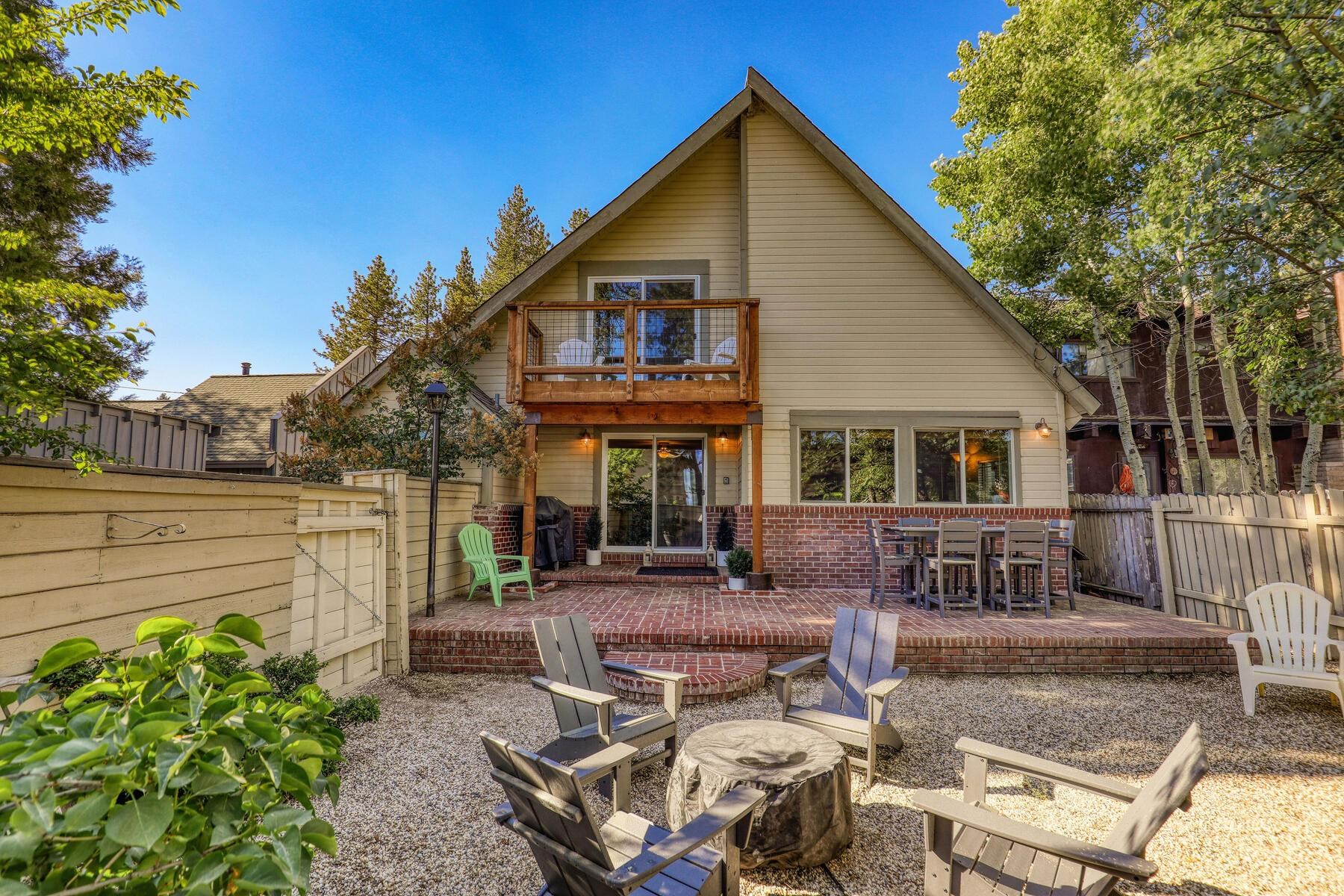 a view of backyard of house with outdoor seating