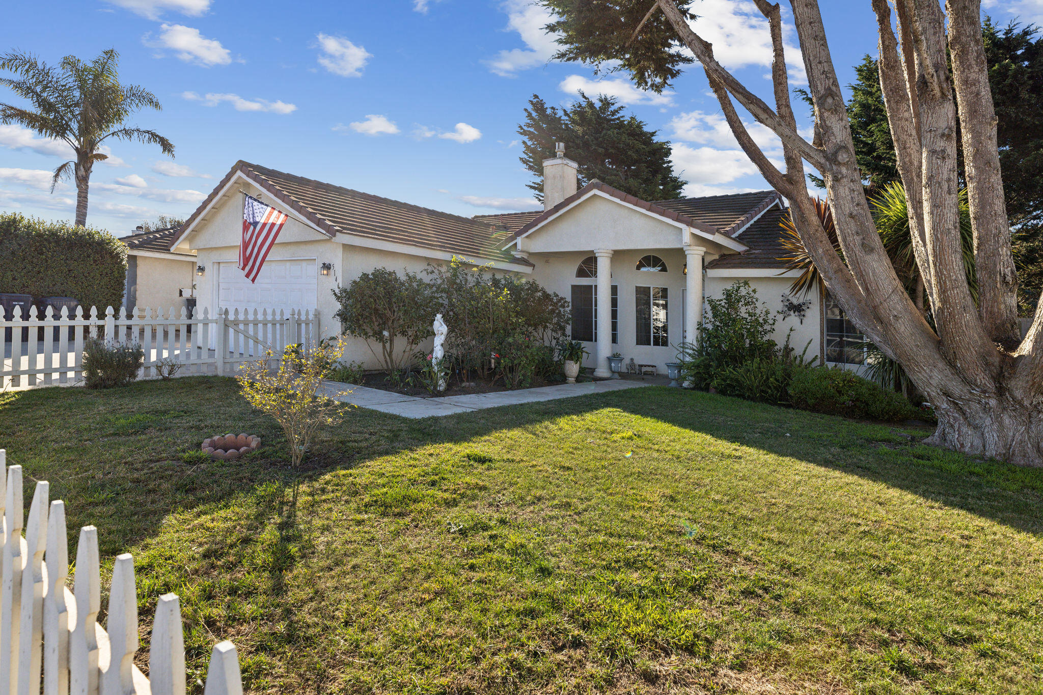 a front view of a house with garden