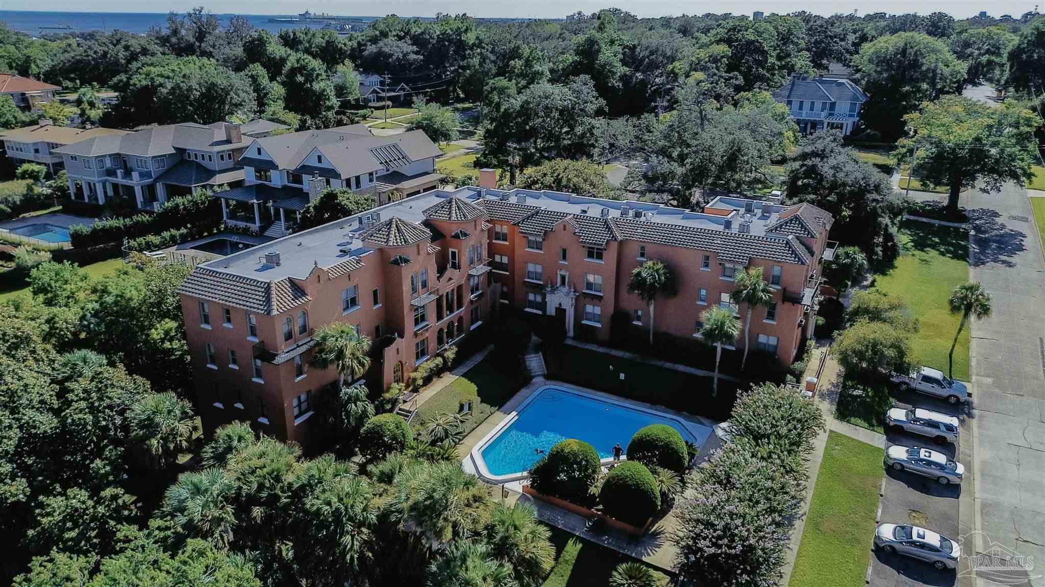 an aerial view of multiple houses with yard