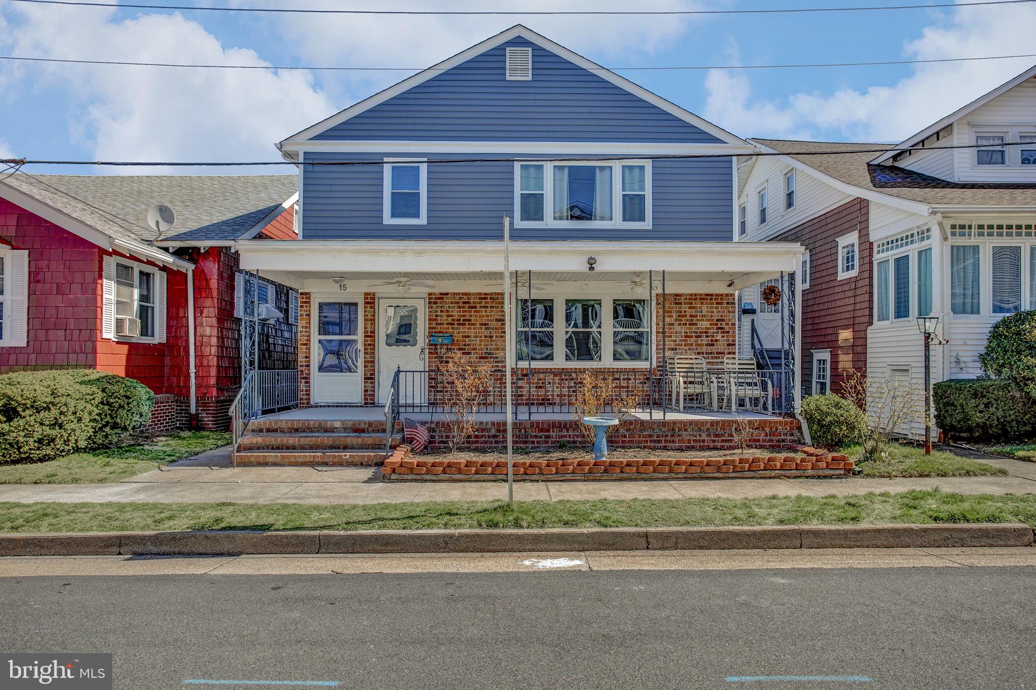 a view of a brick house with a yard in front of it