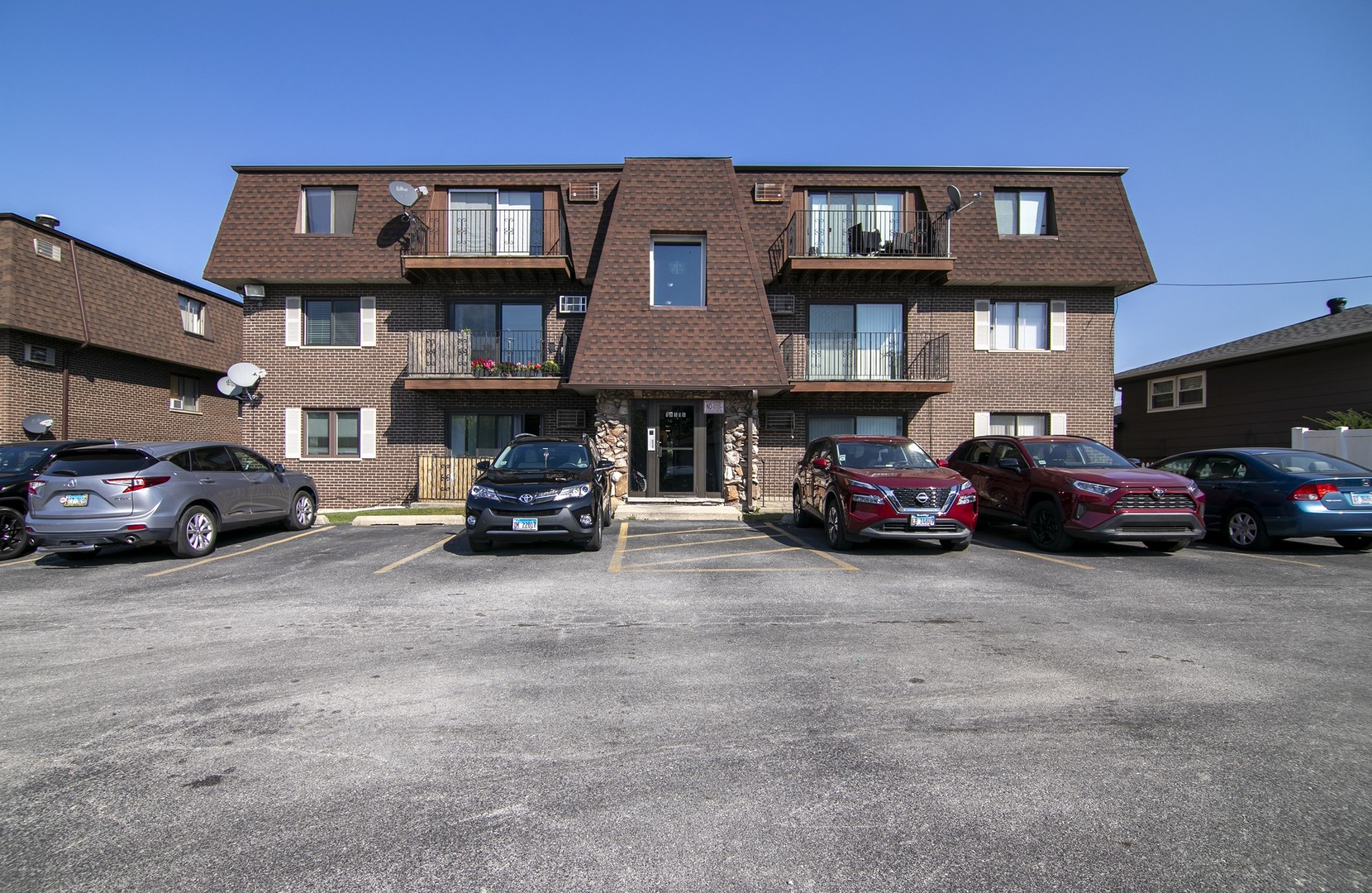 a front view of a residential apartment building with a yard