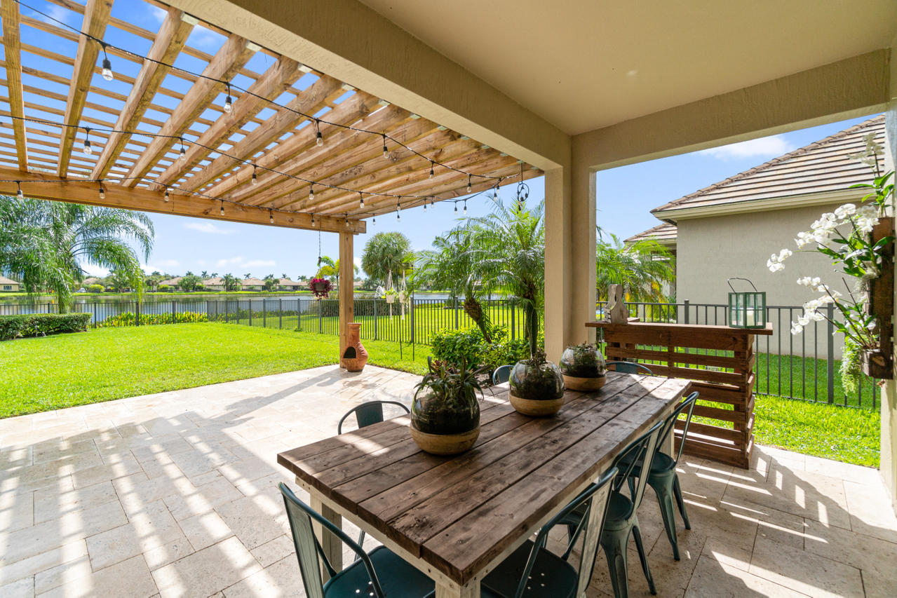 a view of a patio with a table chairs and a backyard