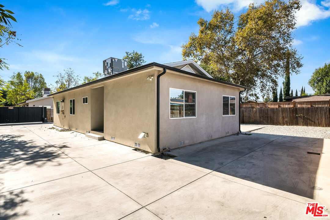 a backyard of a house with wooden fence