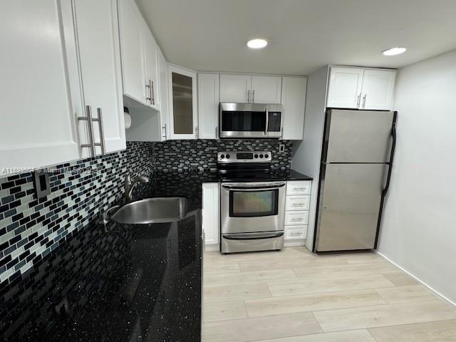 a kitchen with sink and refrigerator