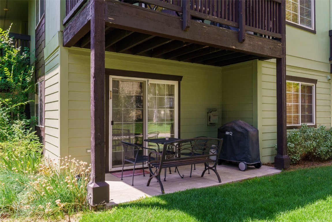 View of patio with a balcony and a grill