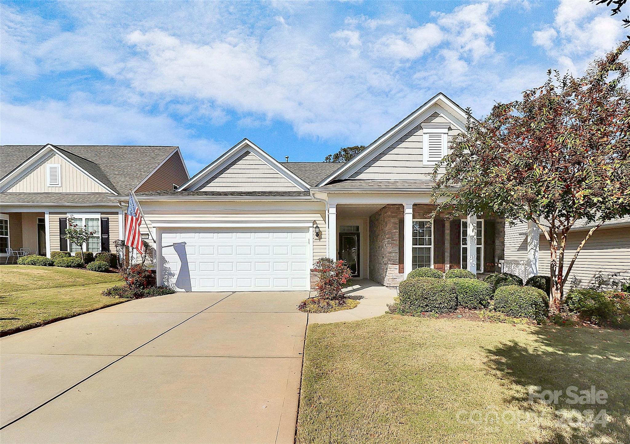 a front view of a house with a yard and outdoor seating