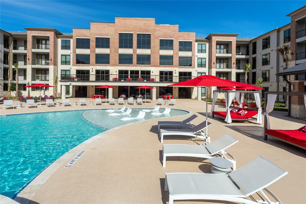 a swimming pool view with a outdoor seating