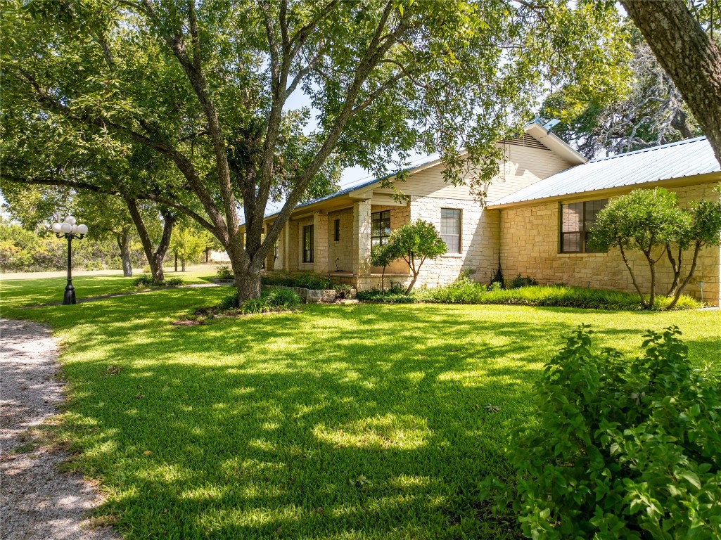 a front view of house with yard and green space