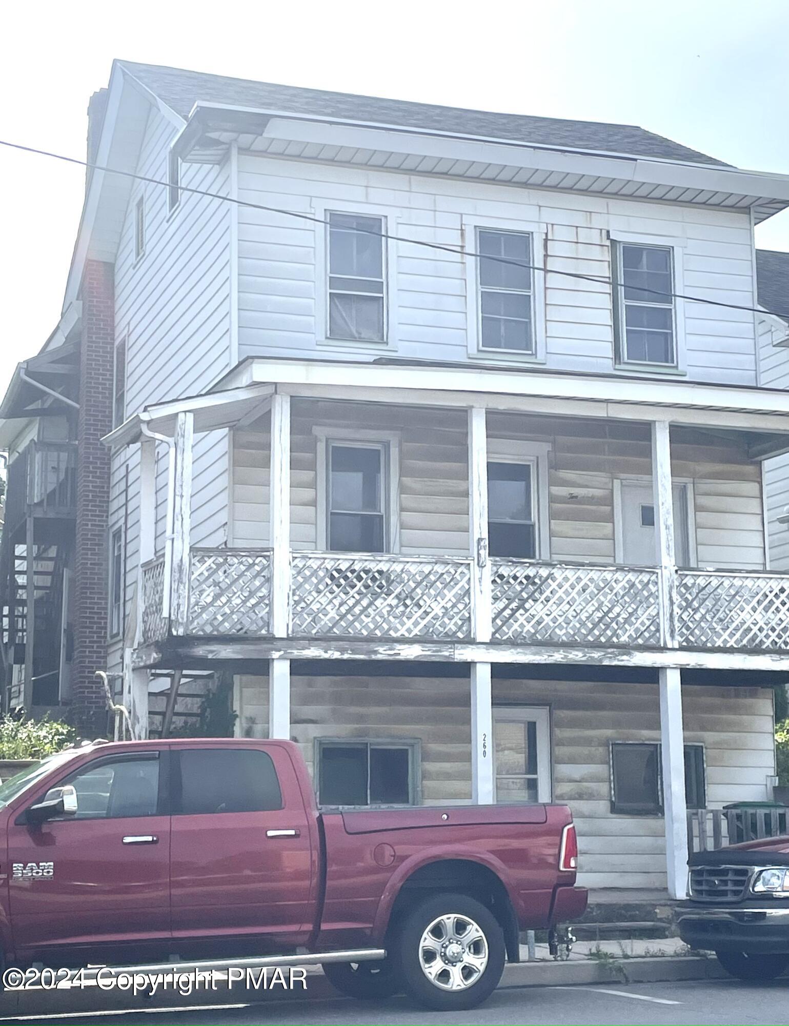 a front view of a house with parking