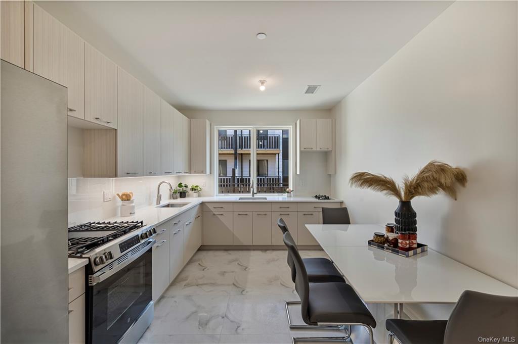 a kitchen with a sink appliances and cabinets