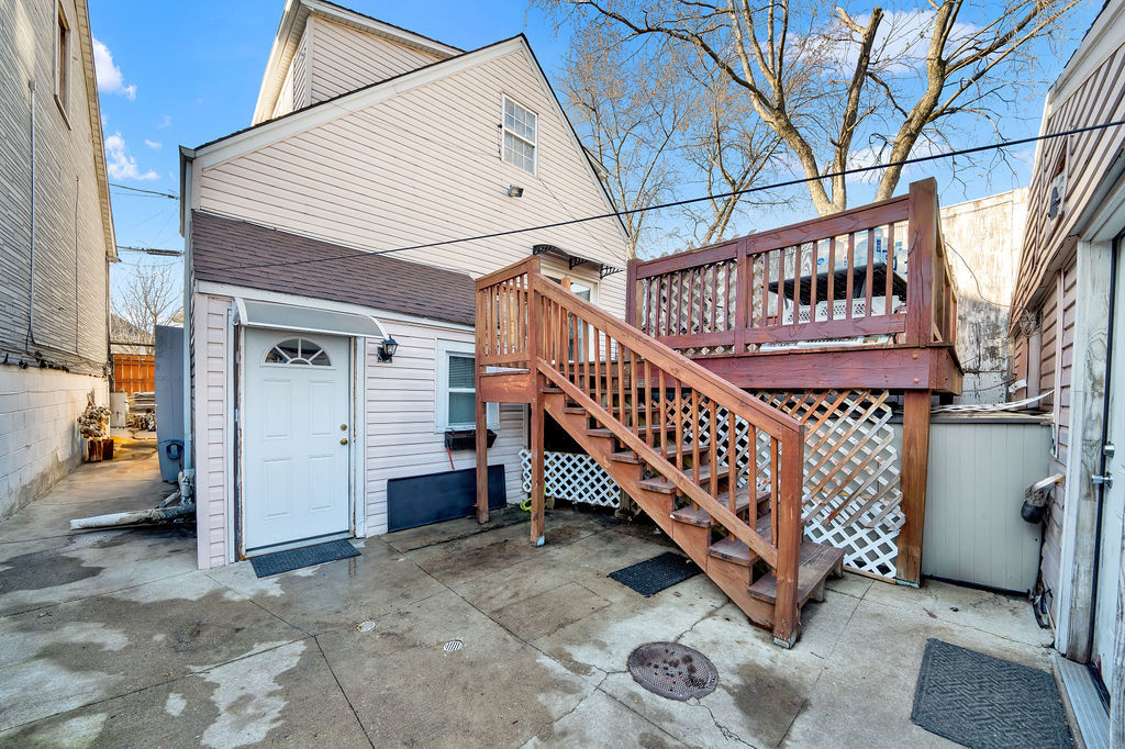 a view of a house with a deck and a yard