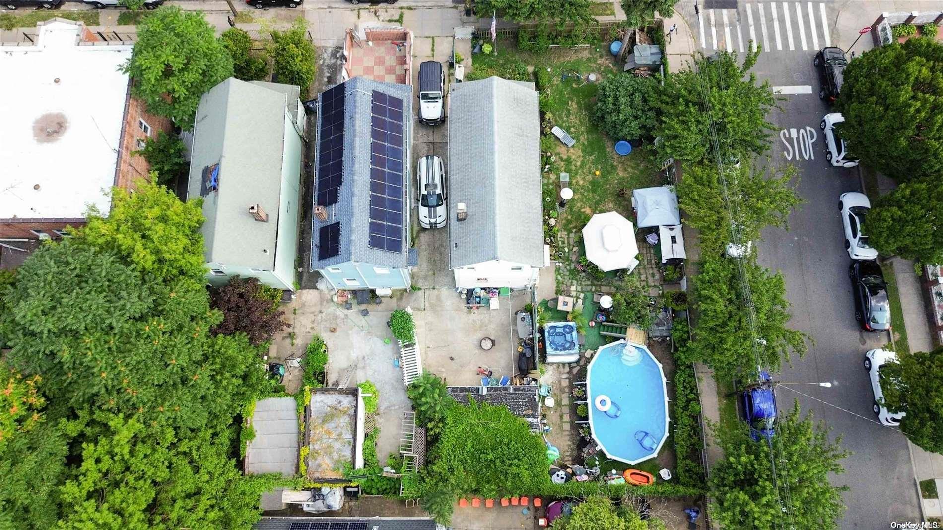 an aerial view of a house with a swimming pool and outdoor seating