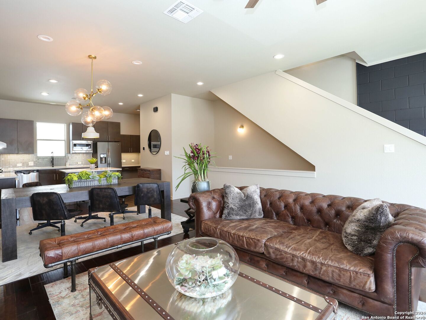 a living room with furniture and a view of kitchen