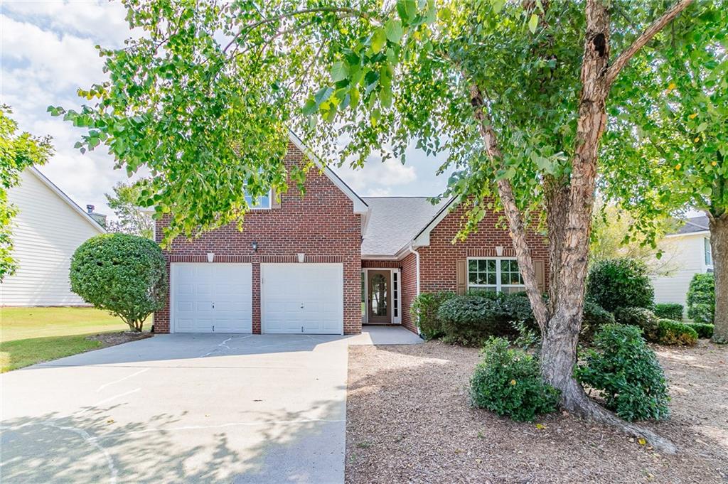 a house that has a tree in front of it