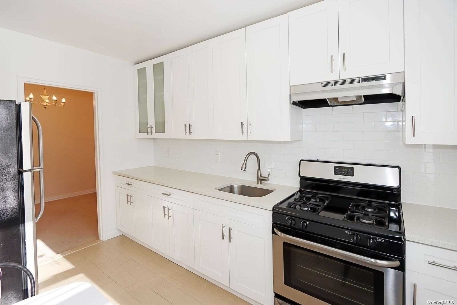 a kitchen with granite countertop cabinets and steel stainless steel appliances