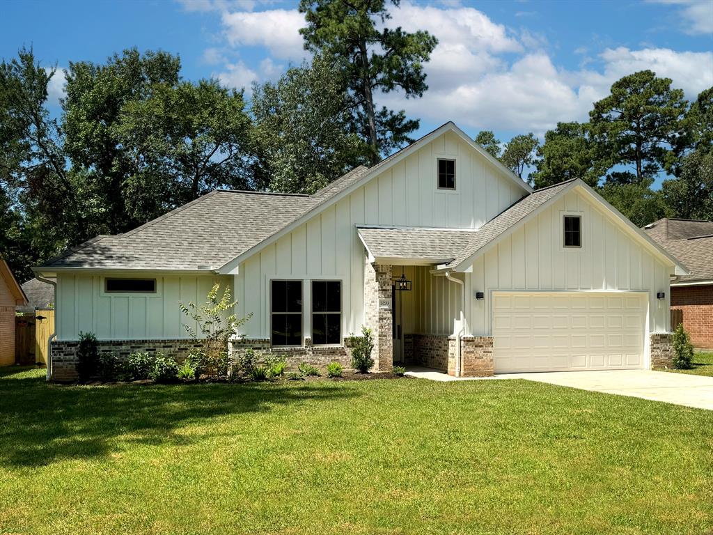 a front view of house with yard and green space