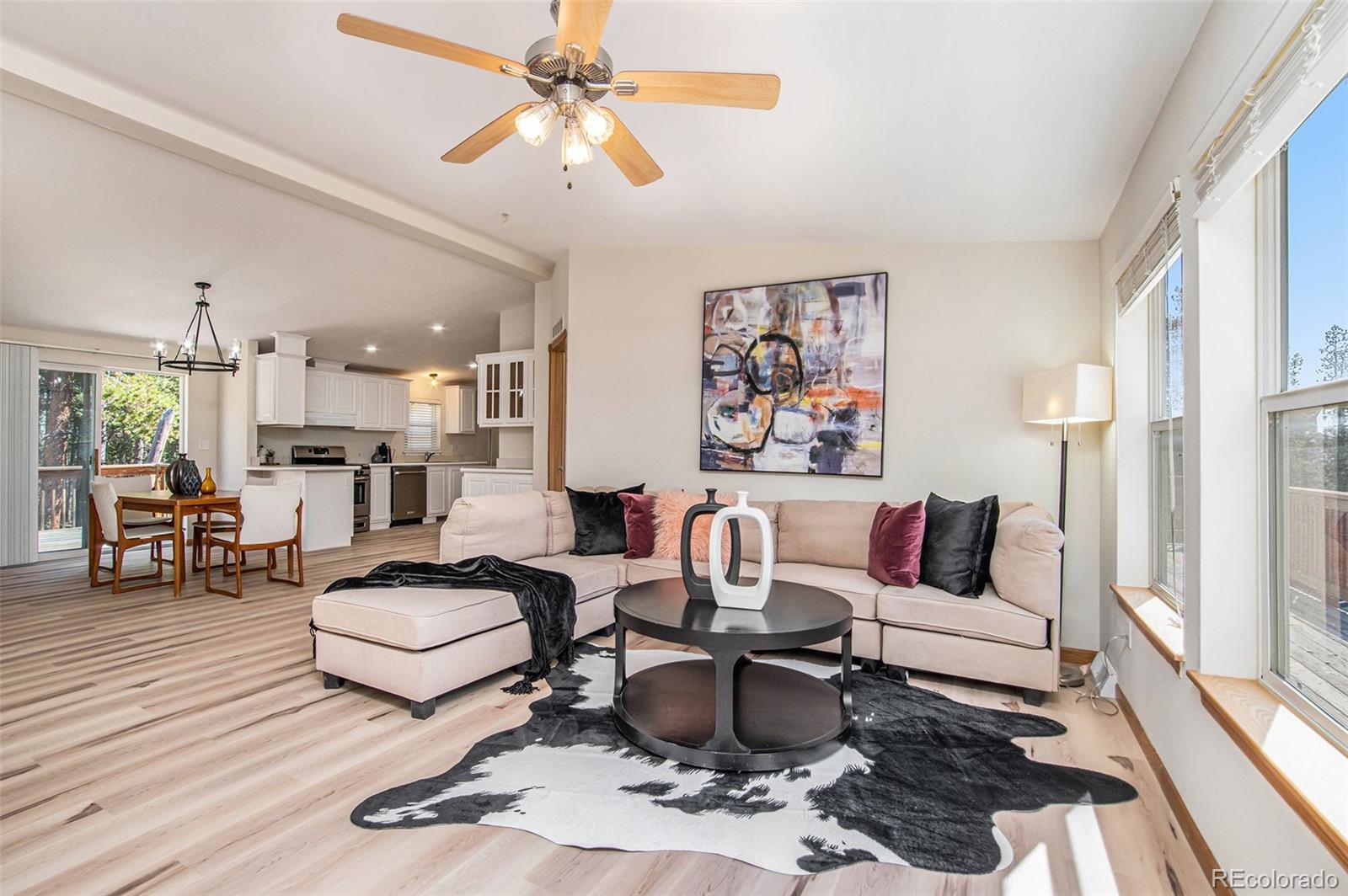 a living room with furniture and a chandelier