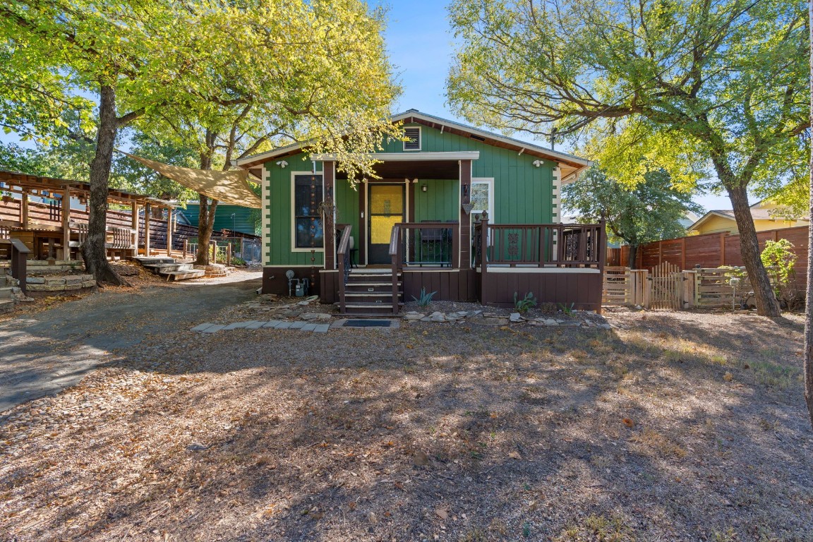 a front view of a house with a tree