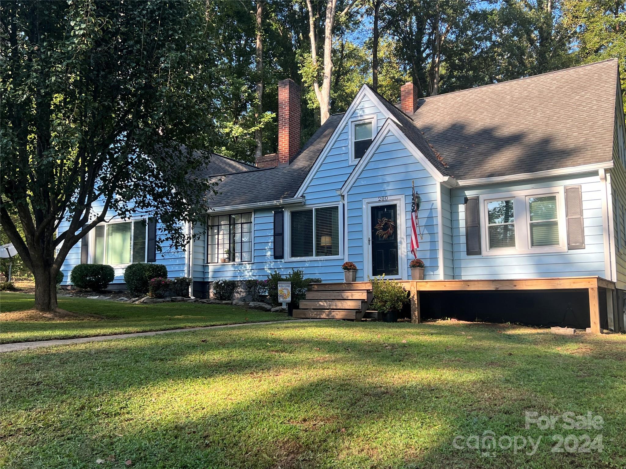 a front view of house with yard and green space