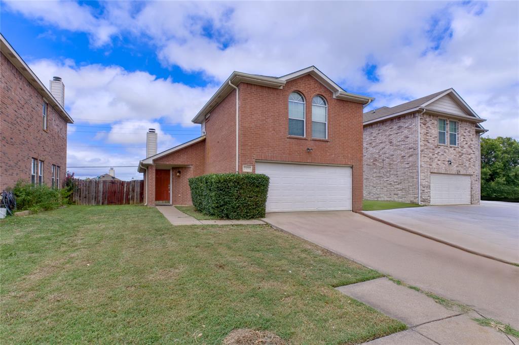 a view of a house with a yard and garage