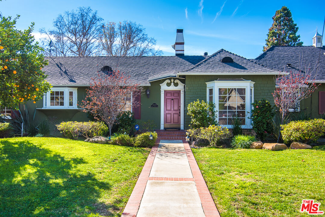 a front view of a house with garden