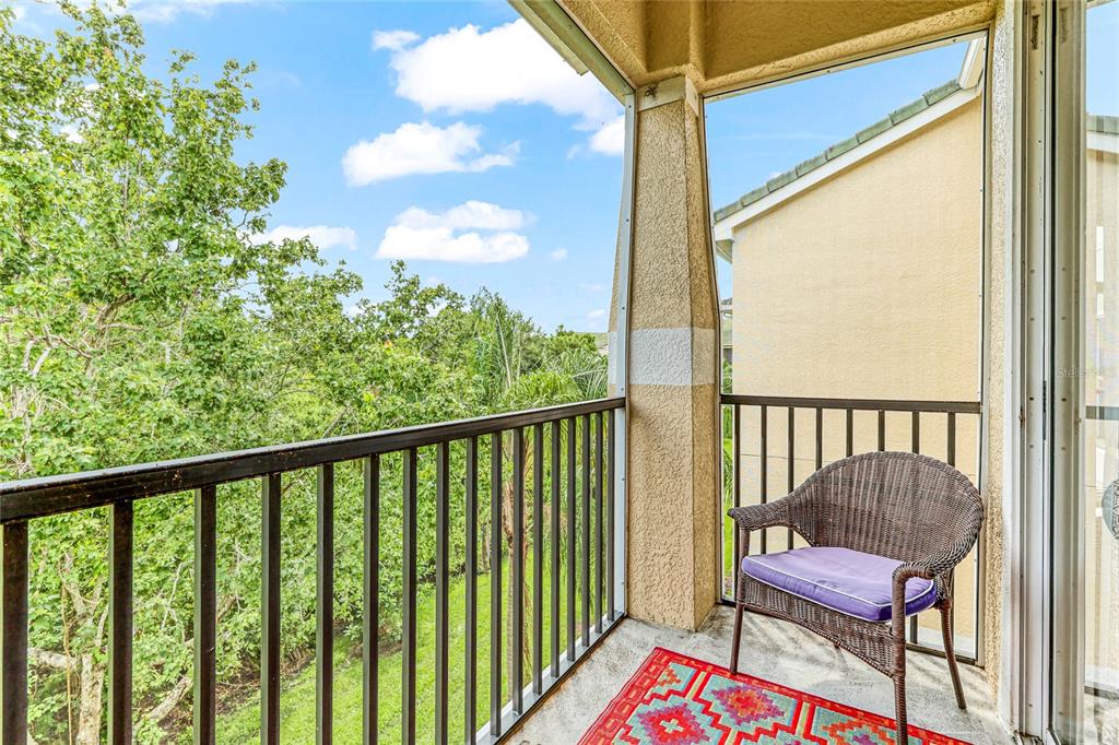 a view of a balcony with chair and a potted plant