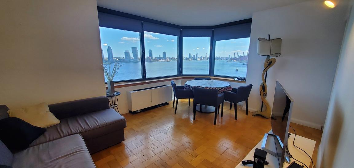 a bedroom with furniture and a large window