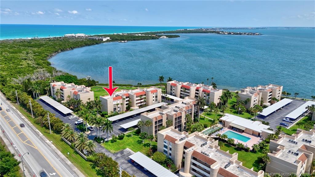 an aerial view of a house with a garden and lake view