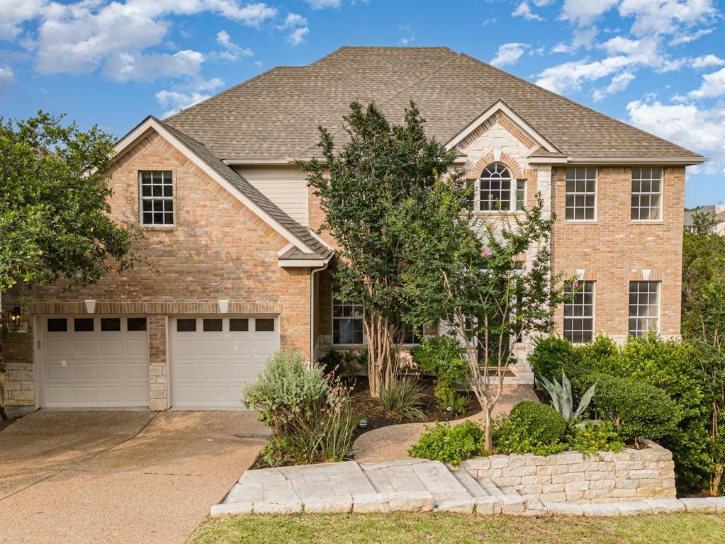 a front view of a house with a yard and garage