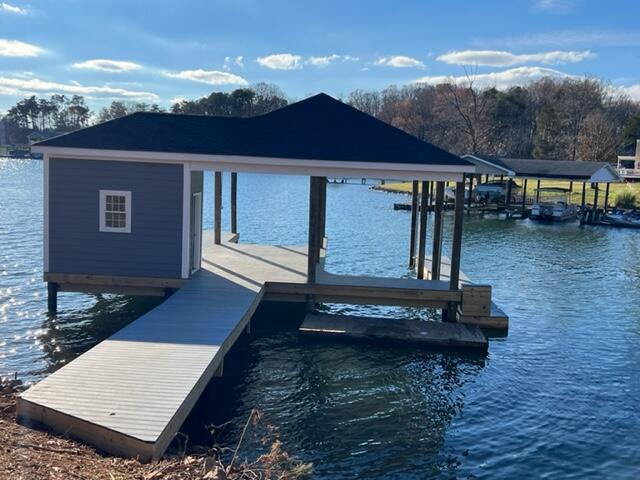 a view of a house with pool and lake view