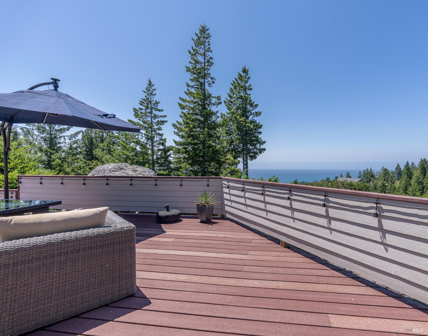 a terrace of a house with wooden floor and outdoor seating