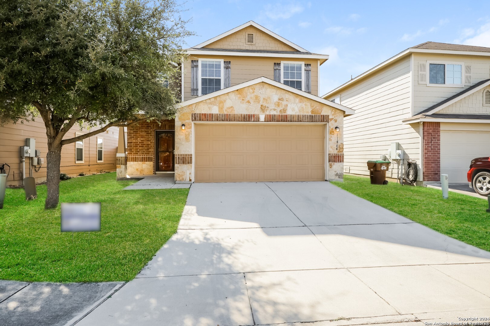 a front view of a house with a yard and garage